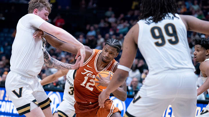 Texas Longhorns guard Tramon Mark (12) muscles his way past Vanderbilt Commodores guard Tyler Nickel (5) during their first round game of the SEC Men's Basketball Tournament at Bridgestone Arena in Nashville, Tenn., Wednesday, March 12, 2025.