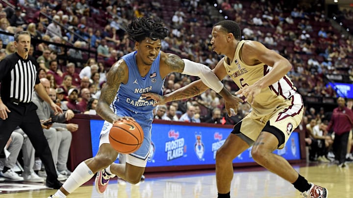 Feb 27, 2023; Tallahassee, Florida, USA; North Carolina Tar Heels guard Caleb Love (2) drives the ball around the defense of Florida State Seminoles guard Matthew Cleveland (35) during the second half at Donald L. Tucker Center. Mandatory Credit: Melina Myers-Imagn Images