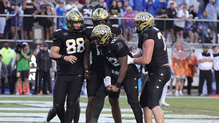 Oct 24, 2026; Orlando, Florida, USA; Central Florida Knights quarterback Keyone Jenkins (12) celebrates a touchdown run during the third quarter against the Brigham Young Cougars at Acrisure Bounce House. Mandatory Credit: Mike Watters-Imagn Images Oct 24, 2026; Orlando, Florida, USA; Central Florida Knights quarterback Keyone Jenkins (12) celebrates a touchdown run during the third quarter against the Brigham Young Cougars at Acrisure Bounce House. Mandatory Credit: Mike Watters-Imagn Images