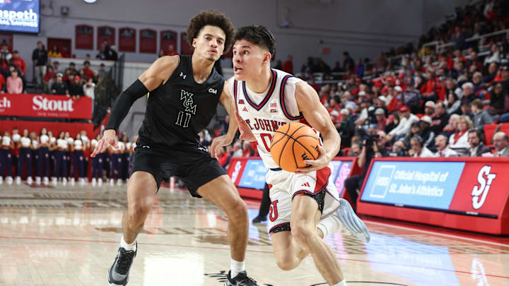 Nov 15, 2025; Queens, New York, USA; St. John's basketball guard Dylan Darling (0) drives past William & Mary Tribe guard Kyle Pulliam (11) in the second half at Carnesecca Arena. Nov 15, 2025; Queens, New York, USA; St. John's basketball guard Dylan Darling (0) drives past William & Mary Tribe guard Kyle Pulliam (11) in the second half at Carnesecca Arena.