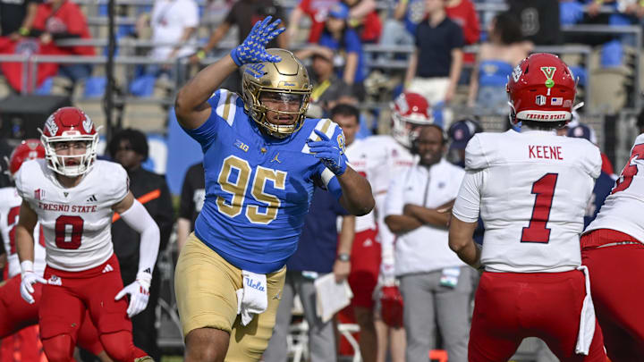 Nov 30, 2024; Pasadena, California, USA; UCLA Bruins defensive lineman Sitiveni Havili Kaufusi (95) pressures Fresno State Bulldogs quarterback Mikey Keene (1) during the second quarter at Rose Bowl. Mandatory Credit: Robert Hanashiro-Imagn Images