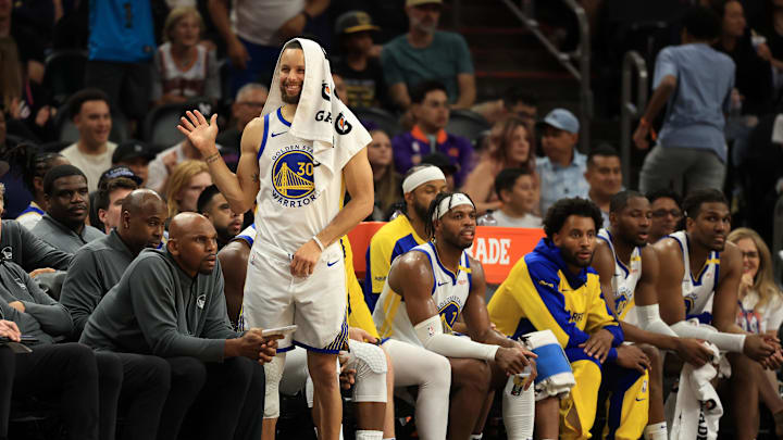 Apr 8, 2025; Phoenix, Arizona, USA; Golden State Warriors guard Stephen Curry (30) reacts on the bench against the Phoenix Suns during the second half at Footprint Center. Mandatory Credit: Mark J. Rebilas-Imagn Images