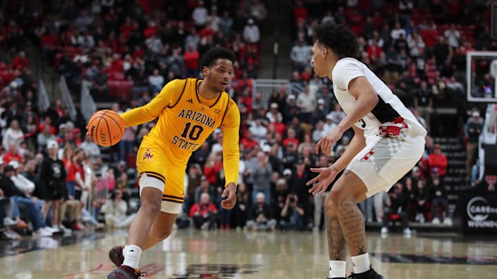 Feb 12, 2025; Lubbock, Texas, USA;  Arizona State Sun Devils guard BJ Freeman (10) dribbles the ball against Texas Tech Red Raiders forward Darrion Williams (5) in the second half at United Supermarkets Arena. Mandatory Credit: Michael C. Johnson-Imagn Images