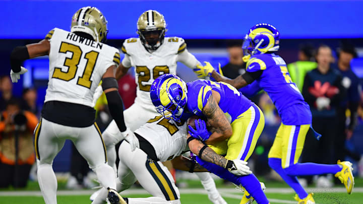 Dec 21, 2023; Inglewood, California, USA; Los Angeles Rams running back Kyren Williams (23) runs the ball against New Orleans Saints safety Tyrann Mathieu (32) during the second half at SoFi Stadium. Mandatory Credit: Gary A. Vasquez-Imagn Images