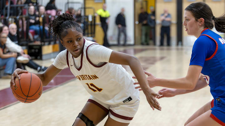 New Britain sophomore Journee Christie (11) led the Golden Hurricanes in scoring with 19 points in the team’s 75-34 win over the St. Paul Falcons in the opening round of the Division I State Tournament. 