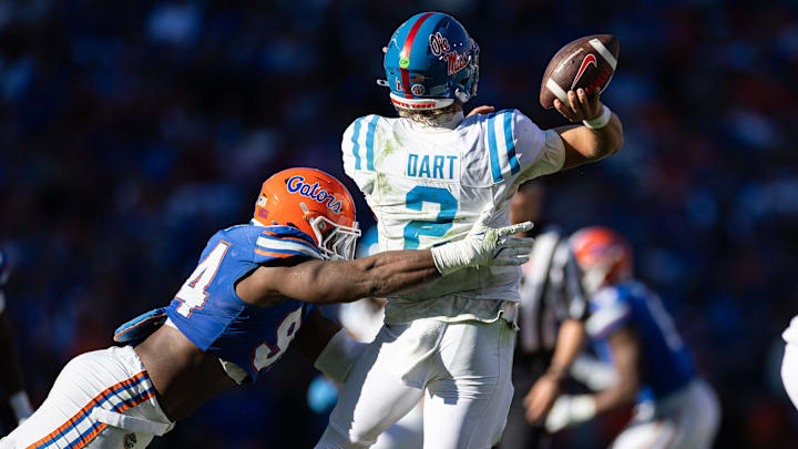 Nov 23, 2024; Gainesville, Florida, USA; Florida Gators defensive end Tyreak Sapp (94) pressures Mississippi Rebels quarterback Jaxson Dart (2) while he throws the ball during the second half at Ben Hill Griffin Stadium. Mandatory Credit: Matt Pendleton-Imagn Images
