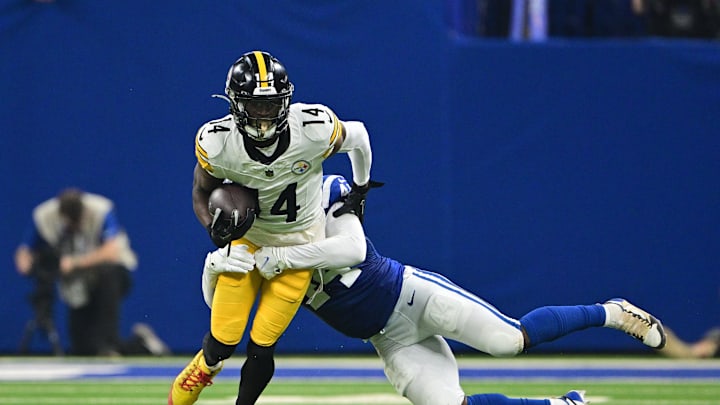Sep 29, 2024; Indianapolis, Indiana, USA; Pittsburgh Steelers wide receiver George Pickens (14) is tackled by Indianapolis Colts linebacker Zaire Franklin (44) during the second quarter at Lucas Oil Stadium. Mandatory Credit: Marc Lebryk-Imagn Images