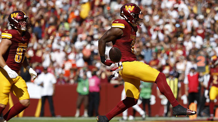 Oct 6, 2024; Landover, Maryland, USA; Washington Commanders running back Brian Robinson Jr. (8) celebrates after scoring a touchdown against the Cleveland Browns during the second quarter at NorthWest Stadium. Mandatory Credit: Geoff Burke-Imagn Images