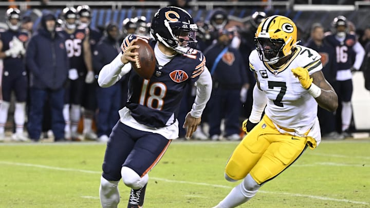 Jan 10, 2026; Chicago, IL, USA;  Chicago Bears quarterback Caleb Williams (18) rolls out as Green Bay Packers linebacker Quay Walker (7) applies the pressure during the first half of an NFC Wild Card Round game at Soldier Field. Mandatory Credit: Matt Marton-Imagn Images