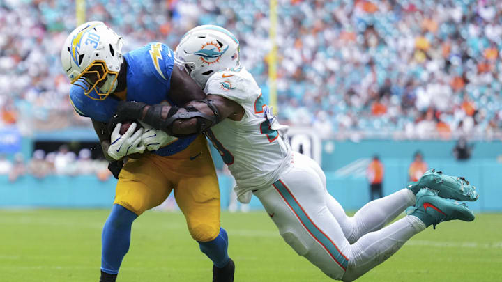 Miami Dolphins linebacker Jordyn Brooks (20) tackles Los Angeles Chargers running back Kimani Vidal (30) during the third quarter at Hard Rock Stadium. 