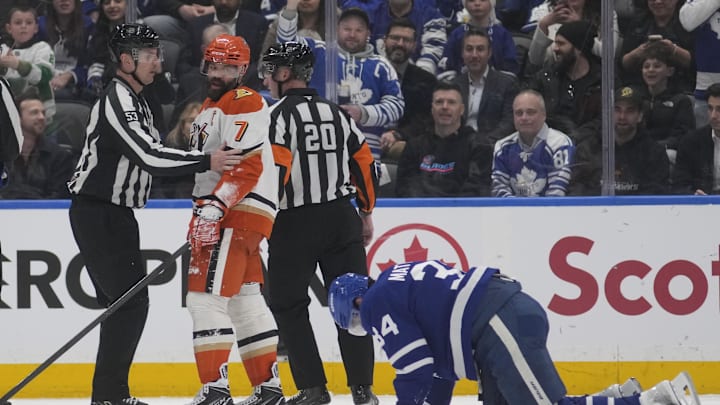 Radko Gudas looks at Auston Matthews after a knee-to-knee hit ended both their nights. 
