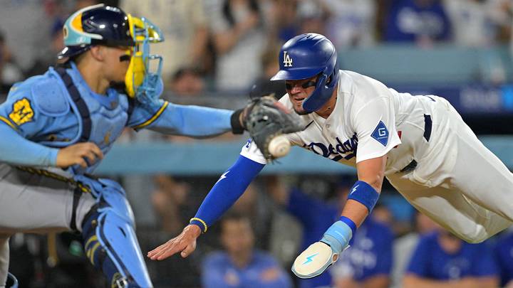 Aug 13, 2026; Los Angeles, California, USA;  Los Angeles Dodgers second baseman Miguel Rojas (72) beats the tag by Milwaukee Brewers catcher William Contreras (24) to score a run in the fifth inning at Dodger Stadium. Mandatory Credit: Jayne Kamin-Oncea-Imagn Images