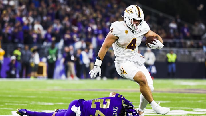 Oct 21, 2023; Seattle, Washington, USA; Arizona State Sun Devils running back Cameron Skattebo (4) breaks a table attempt by Washington Huskies safety Makell Esteen (24) while rushing during the fourth quarter at Alaska Airlines Field at Husky Stadium. Mandatory Credit: Joe Nicholson-Imagn Images Oct 21, 2023; Seattle, Washington, USA; Arizona State Sun Devils running back Cameron Skattebo (4) breaks a table attempt by Washington Huskies safety Makell Esteen (24) while rushing during the fourth quarter at Alaska Airlines Field at Husky Stadium. Mandatory Credit: Joe Nicholson-Imagn Images