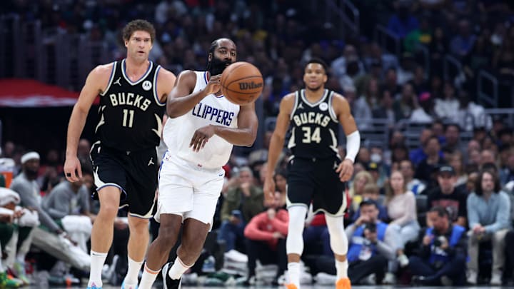 Mar 10, 2024; Los Angeles, California, USA;  Los Angeles Clippers guard James Harden (1) passes the ball in front of Milwaukee Bucks center Brook Lopez (11) during the first quarter at Crypto.com Arena. Mandatory Credit: Kiyoshi Mio-Imagn Images