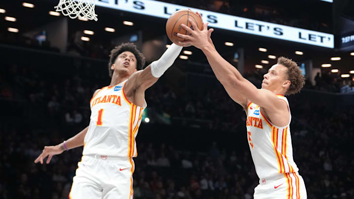 Apr 3, 2026; Brooklyn, New York, USA; Atlanta Hawks forward Jalen Johnson (1) and Atlanta Hawks guard Dyson Daniels (5) grab a rebound against the Brooklyn Nets during the first half at Barclays Center. Mandatory Credit: Gregory Fisher-Imagn Images