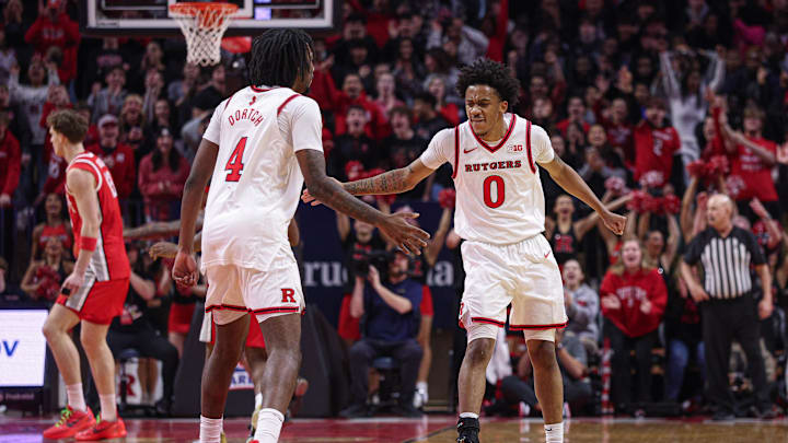 Jan 2, 2026; Piscataway, New Jersey, USA; Rutgers Scarlet Knights guard Tariq Francis (0) celebrates with forward Bryce Dortch (4) after a basket against the Ohio State Buckeyes during the first half at Jersey Mike's Arena. Mandatory Credit: Vincent Carchietta-Imagn Images