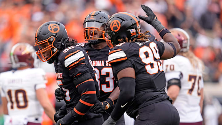 Oklahoma State Cowboys defensive end Jaleel Johnson (95) celebrates a sack with Obi Ezeigbo (33) and Iman Oates (99) in the first half the college football game between the Oklahoma State Cowboys and the Arizona State Sun Devils at Boone Pickens Stadium in Stillwater, Okla., Saturday, Nov., 2, 2024. Oklahoma State Cowboys defensive end Jaleel Johnson (95) celebrates a sack with Obi Ezeigbo (33) and Iman Oates (99) in the first half the college football game between the Oklahoma State Cowboys and the Arizona State Sun Devils at Boone Pickens Stadium in Stillwater, Okla., Saturday, Nov., 2, 2024.