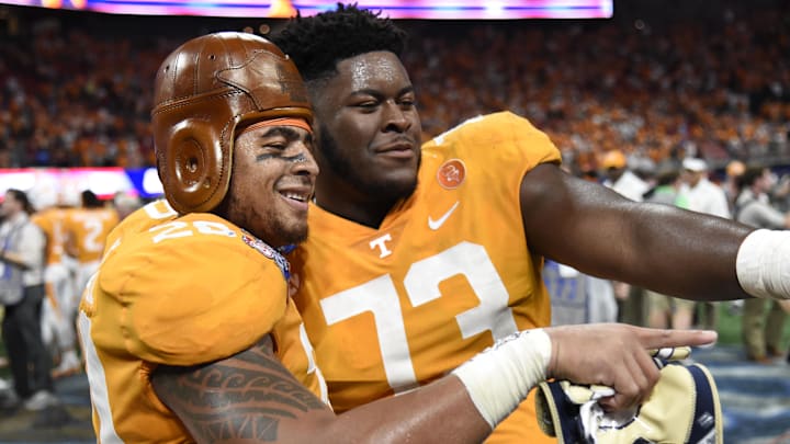 Sep 4, 2017; Atlanta, GA, USA; Tennessee Volunteers linebacker Cortez McDowell (20) wears the old leather helmet as he and offensive lineman Trey Smith (73) react after defeating the Georgia Tech Yellow Jackets at Mercedes-Benz Stadium. Tennessee won 42-41 in two overtimes. Mandatory Credit: Dale Zanine-Imagn Images