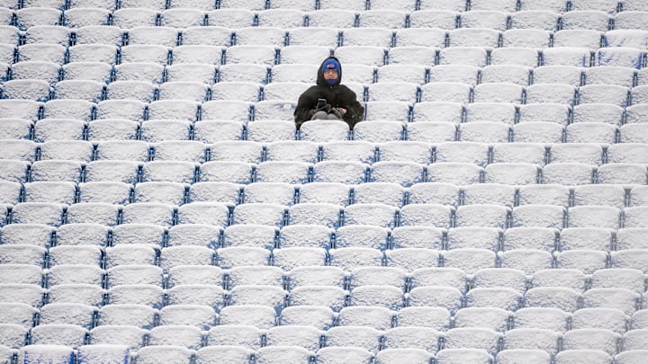 Jan 2, 2022; Orchard Park, New York, USA; A fan sits in the snow covered stands prior to the game