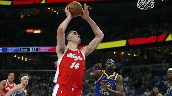 Memphis Grizzlies center Zach Edey (14) shoots as Golden State Warriors forward Draymond Green (23) defends