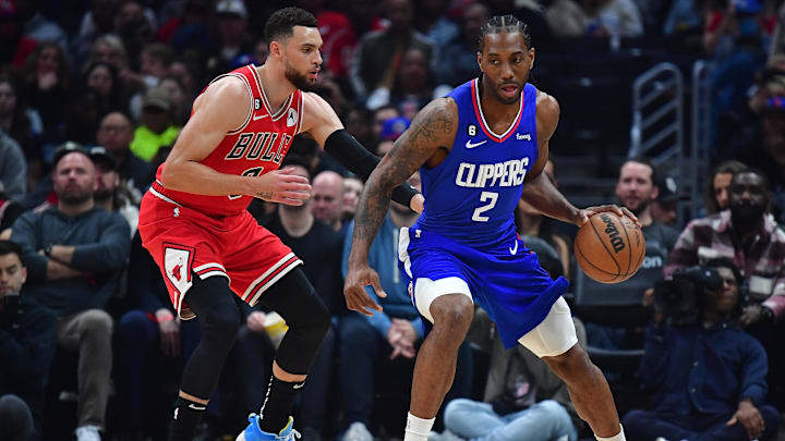 Mar 27, 2023; Los Angeles, California, USA; Los Angeles Clippers forward Kawhi Leonard (2) moves the ball against Chicago Bulls guard Zach LaVine (8) during the first half at Crypto.com Arena. Mandatory Credit: Gary A. Vasquez-Imagn Images
