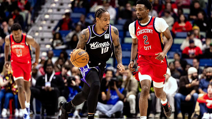 Dec 12, 2024; New Orleans, Louisiana, USA; Sacramento Kings forward DeMar DeRozan (10) brings the ball up court against New Orleans Pelicans forward Herbert Jones (2) during the second half at Smoothie King Center. Mandatory Credit: Stephen Lew-Imagn Images