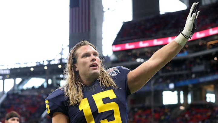 Dec 29, 2018; Atlanta, GA, USA; Michigan Wolverines defensive lineman Chase Winovich (15) waves to fans in the fourth quarter against the Florida Gators in the 2018 Peach Bowl at Mercedes-Benz Stadium. Mandatory Credit: Jason Getz-Imagn Images