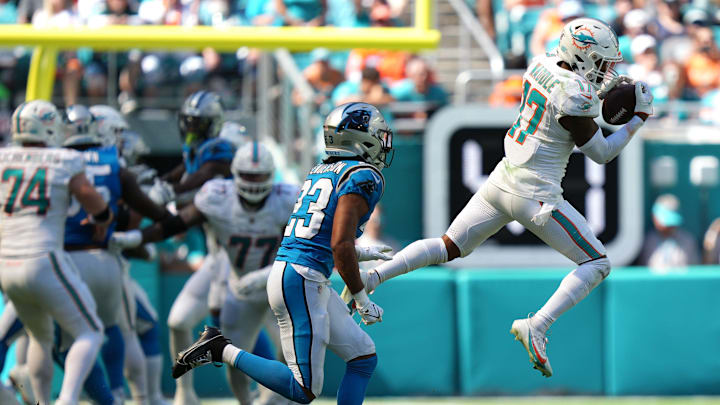Miami Dolphins wide receiver Jaylen Waddle (17) catches a pass over the middle as Carolina Panthers cornerback CJ Henderson (23) closes in during the first half of an NFL game at Hard Rock Stadium in Miami Gardens, Oct. 15, 2023.