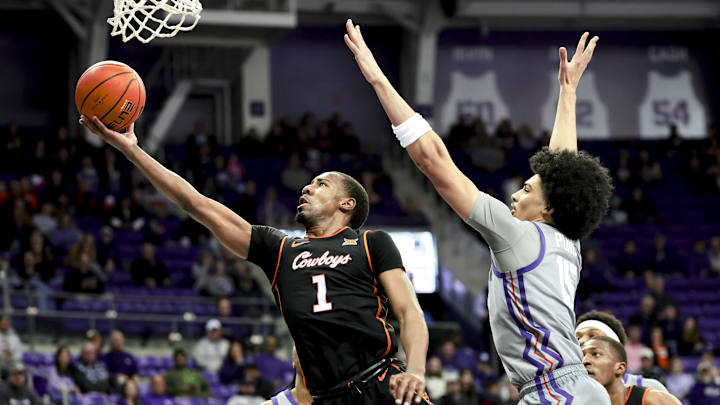 Feb 12, 2025; Fort Worth, Texas, USA; Oklahoma State Cowboys guard Bryce Thompson (1) shoots past TCU Horned Frogs forward David Punch (15) during the second half at Ed and Rae Schollmaier Arena. Mandatory Credit: Kevin Jairaj-Imagn Images Feb 12, 2025; Fort Worth, Texas, USA; Oklahoma State Cowboys guard Bryce Thompson (1) shoots past TCU Horned Frogs forward David Punch (15) during the second half at Ed and Rae Schollmaier Arena. Mandatory Credit: Kevin Jairaj-Imagn Images