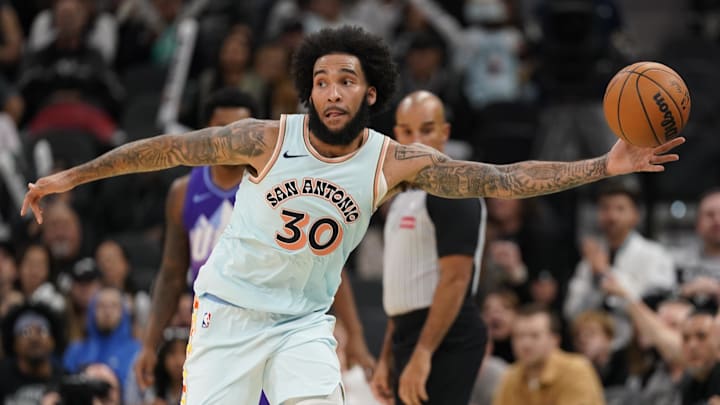 Nov 21, 2024; San Antonio, Texas, USA; San Antonio Spurs forward Julian Champagnie (30) looks to pass while saving the ball from going out of bounds in the second half against the Utah Jazz at Frost Bank Center.