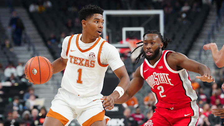 Nov 4, 2024; Las Vegas, Nevada, USA; Texas Longhorns guard Julian Larry (1) dribbles against Ohio State Buckeyes guard Bruce Thornton (2) during the first half at T-Mobile Arena. Mandatory Credit: Stephen R. Sylvanie-Imagn Images