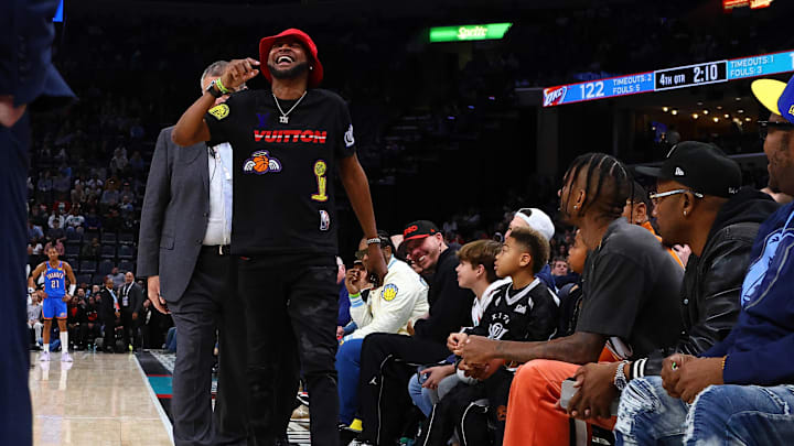 Morant reacts as he is escorted by security off the court. 