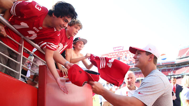 Aug 9, 2025; Santa Clara, California, USA;  San Francisco 49ers quarterback Brock Purdy (13) signs autographs before the game against the Denver Broncos at Levi's Stadium. Mandatory Credit: David Gonzales-Imagn Images