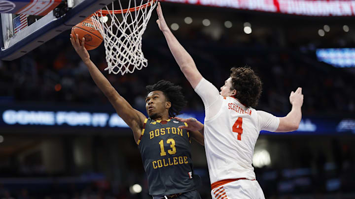 Mar 13, 2024; Washington, D.C., USA;Boston College Eagles guard Donald Hand Jr. (13) shoots the ball as Clemson Tigers forward Ian Schieffelin (4) defends in the first half  at Capital One Arena. Mandatory Credit: Geoff Burke-Imagn Images