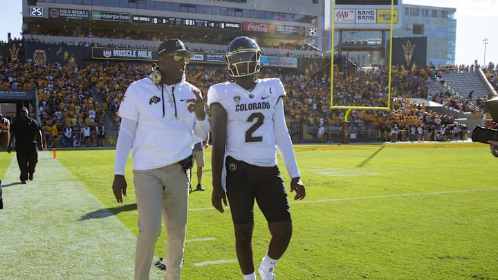 Oct 7, 2023; Tempe, Arizona, USA; Colorado Buffaloes head coach Deion Sanders with son and quarterback Shedeur Sanders (2) against the Arizona State Sun Devils at Mountain America Stadium. Mandatory Credit: Mark J. Rebilas-Imagn Images