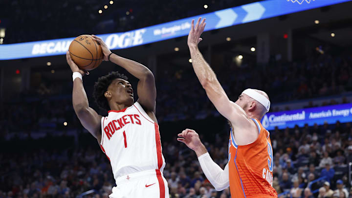 Nov 8, 2024; Oklahoma City, Oklahoma, USA; Houston Rockets forward Amen Thompson (1) shoots as Oklahoma City Thunder guard Alex Caruso (9) defends during the second half at Paycom Center. Mandatory Credit: Alonzo Adams-Imagn Images