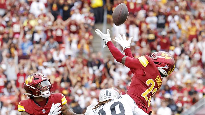 Sep 21, 2025; Landover, Maryland, USA; Washington Commanders cornerback Trey Amos (23) jumps to make a catch as Las Vegas Raiders wide receiver Dont'E Thornton Jr. (10) defends during the first half at Northwest Stadium. Mandatory Credit: Amber Searls-Imagn Images