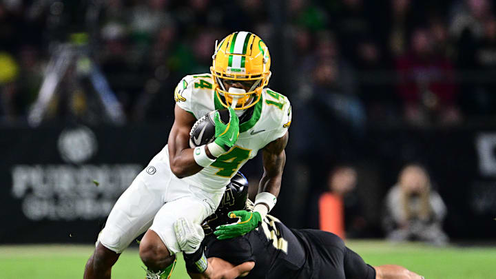 Oct 18, 2024; West Lafayette, Indiana, USA; Oregon Ducks wide receiver Justius Lowe (14) is tackled by Purdue Boilermakers linebacker Yanni Karlaftis (14) during the second half at Ross-Ade Stadium. Mandatory Credit: Marc Lebryk-Imagn Images Oct 18, 2024; West Lafayette, Indiana, USA; Oregon Ducks wide receiver Justius Lowe (14) is tackled by Purdue Boilermakers linebacker Yanni Karlaftis (14) during the second half at Ross-Ade Stadium. Mandatory Credit: Marc Lebryk-Imagn Images