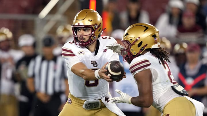 Sep 13, 2025; Stanford, California, USA; Boston College Eagles quarterback Dylan Lonergan (center) hands off to running back Turbo Richard (right) during the third quarter against the Stanford Cardinal at Stanford Stadium. Mandatory Credit: Darren Yamashita-Imagn Images Sep 13, 2025; Stanford, California, USA; Boston College Eagles quarterback Dylan Lonergan (center) hands off to running back Turbo Richard (right) during the third quarter against the Stanford Cardinal at Stanford Stadium. Mandatory Credit: Darren Yamashita-Imagn Images