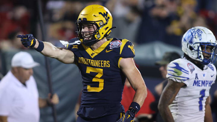 Dec 17, 2024; Frisco, TX, USA; West Virginia Mountaineers wide receiver Hudson Clement (3) reacts after catching a pass against Memphis Tigers defensive back Davion Ross (1) in the fourth quarter at Toyota Stadium. Mandatory Credit: Tim Heitman-Imagn Images