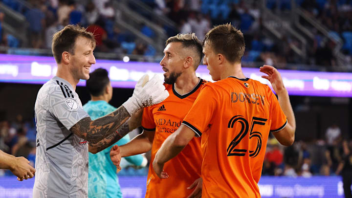 Jul 17, 2022; San Jose, California, USA; Houston Dynamo goalkeeper Steve Clark (12) celebrates with team following a 2-1 come from behind road win.
