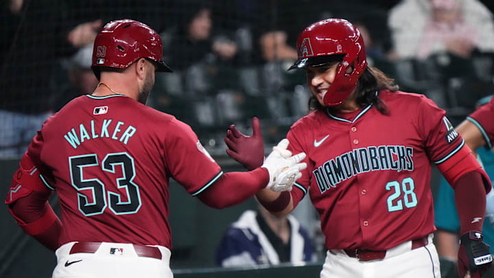 Arizona Diamondbacks' Eugenio Suárez (28) high-fives teammate Christian Walker (53) after his 2-run