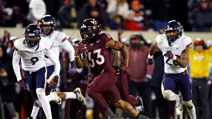 Nov 30, 2024; Blacksburg, Virginia, USA; Virginia Tech Hokies running back Bhayshul Tuten (33) runs the ball for a touchdown during the fourth quarter against the Virginia Cavaliers at Lane Stadium. Mandatory Credit: Peter Casey-Imagn Images Nov 30, 2024; Blacksburg, Virginia, USA; Virginia Tech Hokies running back Bhayshul Tuten (33) runs the ball for a touchdown during the fourth quarter against the Virginia Cavaliers at Lane Stadium. Mandatory Credit: Peter Casey-Imagn Images