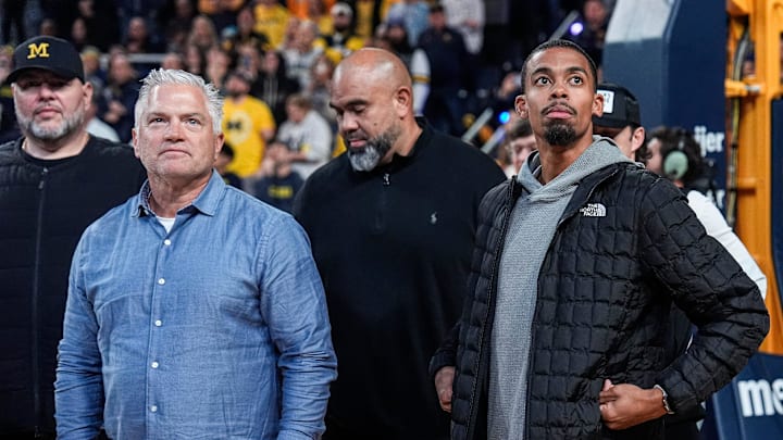 Michigan football tight ends coach Freddie Whittingham, left, and wide receivers coach Micah Simon looks on during football head coach Kyle Whittingham’s introduction during the first half between Michigan and USC at Crisler Center in Ann Arbor on Friday, Jan. 2, 2026.