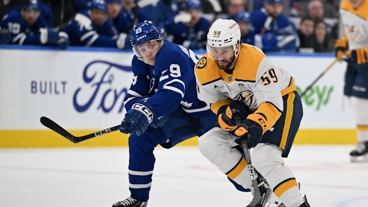Dec 4, 2024; Toronto, Ontario, CAN;  Nashville Predators defenseman Roman Josi (59) carries the puck past Toronto Maple Leafs forward Pontus Holmberg (29) in the second period at Scotiabank Arena. Mandatory Credit: Dan Hamilton-Imagn Images