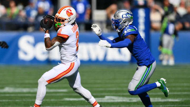 Oct 5, 2025; Seattle, Washington, USA;  Tampa Bay Buccaneers wide receiver Emeka Egbuka (2)  runs after the catch as Seattle Seahawks cornerback Derion Kendrick (1) defends during the first half at Lumen Field. Mandatory Credit: Steven Bisig-Imagn Images