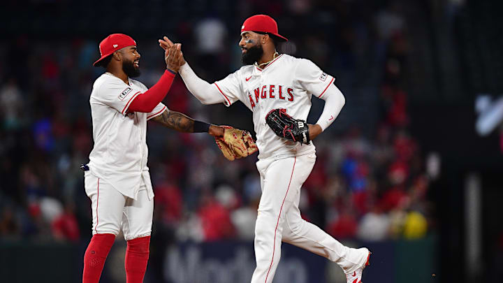 Aug 20, 2025; Anaheim, California, USA; Los Angeles Angels second baseman Luis Rengifo (2) and right fielder Jo Adell (7) celebrate the victory against the Cincinnati Reds at Angel Stadium. Mandatory Credit: Gary A. Vasquez-Imagn Images