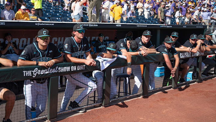 Jun 22, 2025; Omaha, Neb, USA;  The Coastal Carolina Chanticleers watch the LSU Tigers celebrate after winning the College World Series at Charles Schwab Field. Mandatory Credit: Steven Branscombe-Imagn Images
