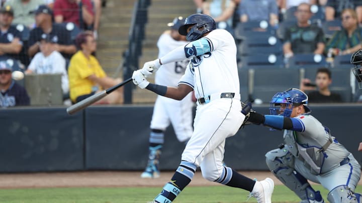 Apr 29, 2025; St. Petersburg, Florida, USA;  Tampa Bay Rays third baseman Junior Caminero (13) doubles during the first inning against the Kansas City Royals at George M. Steinbrenner Field. Mandatory Credit: Kim Klement Neitzel-Imagn Images