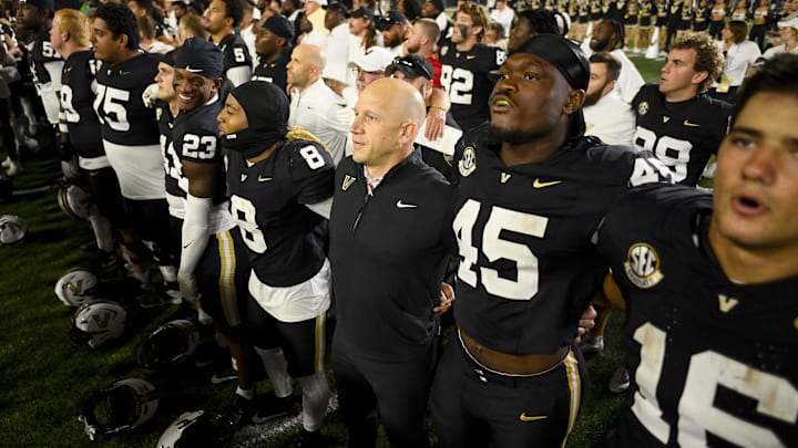 Nov 8, 2025; Nashville, Tennessee, USA;  Vanderbilt Commodores head coach Clark Lea stands with his team during the fight song against the Auburn Tigers during the overtime period at FirstBank Stadium. Mandatory Credit: Steve Roberts-Imagn Images